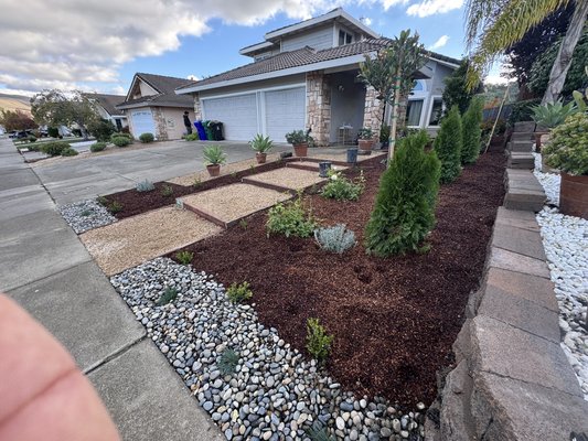 Front Yard Landscape Renovation – Design & Build - This front yard renovation was designed to create a clean, modern, and low-maintenance landscape with strong curb appeal.
The project features decorative gravel, flagstone accents, custom planting, and mulch installation to achieve a cohesive, elegant outdoor space that complements the home’s architecture.
The result is a refreshed front yard that enhances appearance, improves functionality, and adds long-term value to the property. Front Yard Landscape Renovation – Design & Build - This front yard renovation was designed to create a clean, modern, and low-maintenance landscape with strong curb appeal.
The project features decorative gravel, flagstone accents, custom planting, and mulch installation to achieve a cohesive, elegant outdoor space that complements the home’s architecture.
The result is a refreshed front yard that enhances appearance, improves functionality, and adds long-term value to the property.