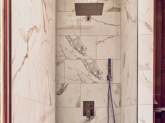 Tile Shower - We built this custom tile shower for a master bathroom remodel. Large 12x24 inch porcelain on the walls and a square charcoal mosaic for the shower floor.
