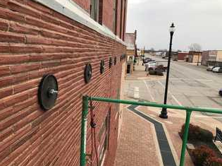 Wall Repair in Watonga, OK - Challenge

This concerned customer was worried that there were some structural issues with his historic building. The brick had some fractures and seemed as if it was pulling away from the actual building. There are many different reasons as to why this could happen, but in this situation, it was simply because the building was old and beginning to deteriorate. The owner didn’t want to see his unique building crumble to the ground. He reached out to Team Vesta and we referred him to an engineer, Martin Henry. With the collaboration of Martin’s report and our’s, we came up with a plan to fix and preserve this historic building.

 
Solution

According to Martin’s report the “1st-level brick facing has begun to pull away from the “integral” and “interior” brick layers.  When the building’s south-facing wall was inspected from the 2nd-level on the inside, it was plainly visible, further aided by client installed gauge blocks, that the entire cross-section of the wall is detached and falling away. When looking at the building’s west-facing wall, a vertically wall fracture was found just in front of or to the south of one particular window suggesting the location of the failure that is responsible for the wall’s movement.”

Team Vesta’s Solution? Install Wall Anchors, decorative wall plates, and a 8x8 anchor plate in floor system of the 2nd story of building. The Vesta team provided a tightening kit to tighten and fasten the wall anchor system to wall. Also, to tighten and monitor wall system for movement. After installation, the walls were bench marked and documented for customer. The Vesta team acquired appropriate permits and had a third party evaluation performed by the engineering firm, Hall Engineering Group, (Martin Henry) per local building code. After the job was complete the customer was happy with the work that had been done. He is happy to have his building stable and preserved. Looks like it’s another win-win for Team Vesta! We are always willing to do whatever it takes to make sure our customers are happy with our work and service!

 
Project Summary

Engineer: Martin Henry