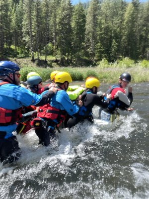Swiftwater Rescue & Wilderness First Aid Training - Professional-grade river safety training on the Payette River. Our swiftwater rescue courses train fire departments, search and rescue teams, ambulance crews, and river guides in swimming rescues, throw bag techniques, rope systems, entrapment, and scenario-based drills — at our River Center or on-site in your area of operation. Recreational river rescue classes give rafters and kayakers the same life-saving skills. We also offer hands-on, fully outdoor wilderness first aid and CPR certification covering patient assessment, traumatic injury, and environmental emergencies. Train as a team and know you can act together when it matters.