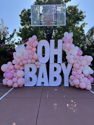 Oh Baby Love - This charming setup is perfect for celebrating life’s sweetest moments! Featuring a mix of soft blush, pastel pink, and white balloons, it creates a dreamy and elegant vibe for any baby shower or gender reveal. The highlight of the decor is the large “OH BABY” marquee letters, making it an eye-catching photo backdrop and the ultimate statement piece for your event.
Designed to bring warmth and joy, this balloon arrangement works beautifully for outdoor or indoor celebrations, giving your guests the perfect spot for photos and unforgettable memories. Oh Baby Love - This charming setup is perfect for celebrating life’s sweetest moments! Featuring a mix of soft blush, pastel pink, and white balloons, it creates a dreamy and elegant vibe for any baby shower or gender reveal. The highlight of the decor is the large “OH BABY” marquee letters, making it an eye-catching photo backdrop and the ultimate statement piece for your event.
Designed to bring warmth and joy, this balloon arrangement works beautifully for outdoor or indoor celebrations, giving your guests the perfect spot for photos and unforgettable memories.