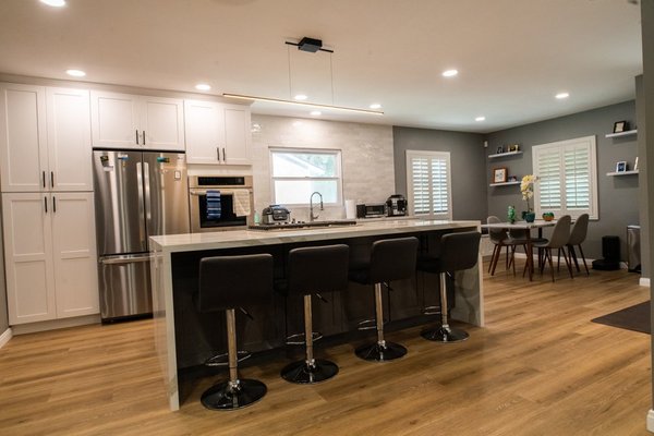 Home Remodel - This home remodel came out beautifully. The exterior remodel consisted of landscaping aspects such as laying artificial grass and black mulch around surrounding trees and plants. The kitchen remodel features a waterfall island, dishwasher, wall oven, cooktop, fridge, a kitchen nook, and a storage/sitting bench. Next to the kitchen is also a mudroom/laundry room.