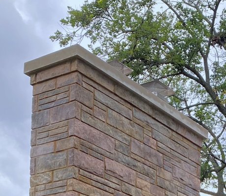 Chimney Crown Construction & Power Washing - This chimney began to fall apart at the top due to bad chimney crown construction. We removed the top layer of stone and concrete and poured a new chimney crown with all the proper elements to prevent future damage to the chimney. Additional work included tuckpointing, power washing, extending the top clay flue liners, and installation of new stainless-steel rain/animal guards.