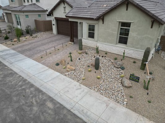 Complete Front Yard Remodel In The Talinn Community Located In North Phoenix - This beautiful front yard transformation we did in North Phoenix is one of our absolute favorites. We completely scraped the yard and removed all of the overgrown shrubs, messy gravel, and then added some decorative mounding, decorative drainage swales, Surface select boulders, a complete LED lighting system, and some beautiful drought-tolerant desert plants. This project, from start to finish, took approximately 3 days, and we worked with the client's HOA for approval before we started. We also hand-selected all the Cacti and succulents from one of our locally sourced wholesale nurseries. Creating this transformation was an absolute pleasure, and we are very proud to share. This project cost approximately $15,000. If you are in need of a front yard refresh and are looking to add some great curb appeal, we can definitely help with that. We hope to work with you soon!
Sean Varnum
Landscape 20/20 Complete Front Yard Remodel In The Talinn Community Located In North Phoenix - This beautiful front yard transformation we did in North Phoenix is one of our absolute favorites. We completely scraped the yard and removed all of the overgrown shrubs, messy gravel, and then added some decorative mounding, decorative drainage swales, Surface select boulders, a complete LED lighting system, and some beautiful drought-tolerant desert plants. This project, from start to finish, took approximately 3 days, and we worked with the client's HOA for approval before we started. We also hand-selected all the Cacti and succulents from one of our locally sourced wholesale nurseries. Creating this transformation was an absolute pleasure, and we are very proud to share. This project cost approximately $15,000. If you are in need of a front yard refresh and are looking to add some great curb appeal, we can definitely help with that. We hope to work with you soon!
Sean Varnum
Landscape 20/20