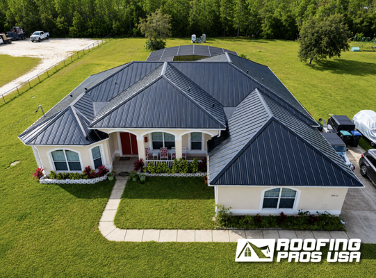 Metal Roof Highlights - Metal roofing is one of the best investments a Florida homeowner can make, built to handle heavy rain, high winds, and intense heat while delivering serious curb appeal. Whether the job calls for standing seam panels or metal shingles with a more traditional profile, we bring the same level of precision to every section of every roof.
Our team handles everything from panel layout and seam work to trim, flashing, and final finish, with a focus on clean lines, tight transitions, and a result that holds up as well as it looks. Metal roofs also reflect sunlight rather than absorbing it, which helps keep homes cooler and lowers energy costs over time.
Browse through to see the variety of homes we've completed and get a sense of what metal roofing can look like on your home. Metal Roof Highlights - Metal roofing is one of the best investments a Florida homeowner can make, built to handle heavy rain, high winds, and intense heat while delivering serious curb appeal. Whether the job calls for standing seam panels or metal shingles with a more traditional profile, we bring the same level of precision to every section of every roof.
Our team handles everything from panel layout and seam work to trim, flashing, and final finish, with a focus on clean lines, tight transitions, and a result that holds up as well as it looks. Metal roofs also reflect sunlight rather than absorbing it, which helps keep homes cooler and lowers energy costs over time.
Browse through to see the variety of homes we've completed and get a sense of what metal roofing can look like on your home.