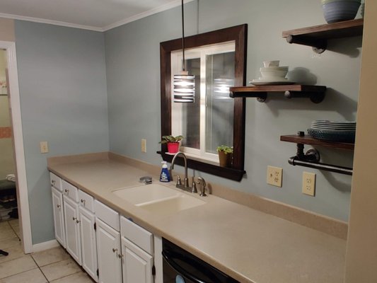 Kitchen Refresh - This is a project where the customer was anxious to start her own work, so she went ahead and removed the kitchen cabinets and the tile backsplash only the find the wall and ceiling were in rough condition.  That is when she reached out to Howland Home Services.  She had walked a few other people through and felt like they were less competent and yet wanted more money.  

The before picture shows the condition when we walked through the door.  We transitioned new drywall into the ceiling and skim coated the walls.  A fresh coat of paint, some new shelves, and some custom trim around the window, and this kitchen has a fresh modern feel.  

I must admit, I was skeptical at first of removing the cabinets, but when we completed the work, the kitchen is much more open and inviting.

Give us a call to help make your kitchen dreams a reality.