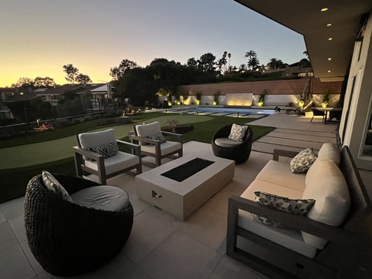 La Jolla Backyard Renovation - This La Jolla backyard remodel was a complete tear out of the old, outdated landscape and hardscaping and construction of a complete new yard. The new design included: Porcelain pavers for the patio seating areas, oversized poured concrete stepping pads to connect different living areas, a new outdoor kitchen and grill, a large synthetic putting green and artificial turf, custom water feature, all new drought tolerant planting with drip irrigation, natural gas fire pit, aluminum fencing, gates and new landscape lighting throughout. The client also had the pool remodeled at the same time (done by another contractor). This project took approximately 4 months to complete from start to finish. La Jolla Backyard Renovation - This La Jolla backyard remodel was a complete tear out of the old, outdated landscape and hardscaping and construction of a complete new yard. The new design included: Porcelain pavers for the patio seating areas, oversized poured concrete stepping pads to connect different living areas, a new outdoor kitchen and grill, a large synthetic putting green and artificial turf, custom water feature, all new drought tolerant planting with drip irrigation, natural gas fire pit, aluminum fencing, gates and new landscape lighting throughout. The client also had the pool remodeled at the same time (done by another contractor). This project took approximately 4 months to complete from start to finish.