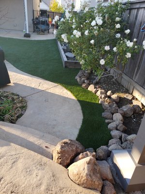 REPAIR, GROOMING of 8 yr Old Artificial Turf & New Artificial Grass - After 8 years of enjoying this backyard artificial lawn, the family added a new patio and needed to reset the edge of the lawn against it.  Along the other side of the new patio, the family wanted to add another lawn.
