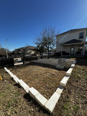 Retainer Wall with French Drain - The customer had a huge slope in their backyard and wanted to make the area usable! We cut the backyard in half and build a retainer wall, make the lower area flat and level, and added a French drain for drainage! We reused the same sod to save the customer money and added steps for easy access to the bottom level! Retainer Wall with French Drain - The customer had a huge slope in their backyard and wanted to make the area usable! We cut the backyard in half and build a retainer wall, make the lower area flat and level, and added a French drain for drainage! We reused the same sod to save the customer money and added steps for easy access to the bottom level!