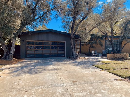 Modern Door Upgrade - This project shows the before and after of a one-piece, wood, tilt-up door that was long past it’s prime. The new garage door, Avante AX Series by Clopay, adding a huge increase in curb appeal. As well as, offering a much smoother and safer operation.