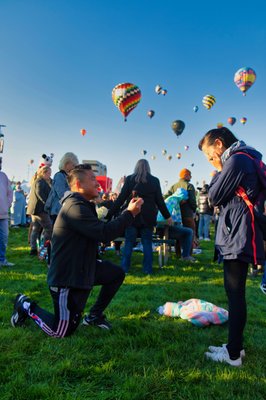 Justin Thai Engagement - Justin wanted to ask his girlfriend to marry him but he wanted to make it a true moment to remember.  He decided that the Albuquerque International Balloon fiesta was the place to do it.  He and his future bride flew in from San Diego the day before and got up at 3:00 am to get to the park.  He waited for the mass ascension, got down on one need and popped the question.  How could she resist, she said yes and the rest is history.  I'm so pleased that Justin asked me to record the moment for him.