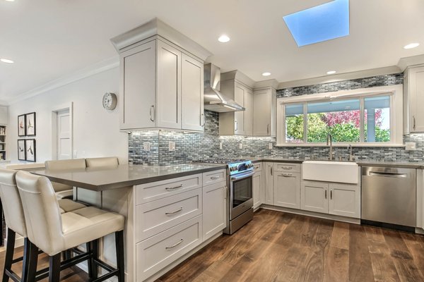 Kitchen and Bath Design & Remodel - This remodeled kitchen used the existing space by replacing dark cabinetry with light gray cabinets making the kitchen brighter and appear larger.  Kitchen design and cabinetry provided by Kitchen Design Services.