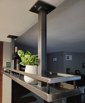 Suspended steel shelf - This suspended steel shelf was secured to ceiling studs and its very solid. Able to support a good deal of weight despite the use of thin gauge steel throughout. Customer opted for a polished steel finish, we applied clear coat to keep that shine from ever rusting. Suspended steel shelf - This suspended steel shelf was secured to ceiling studs and its very solid. Able to support a good deal of weight despite the use of thin gauge steel throughout. Customer opted for a polished steel finish, we applied clear coat to keep that shine from ever rusting.
