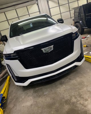 Full wrap and chrome delete on a 2022 Cadillac Escalade - Satin pearl white wrap with full chrome delete and blacked out wheels