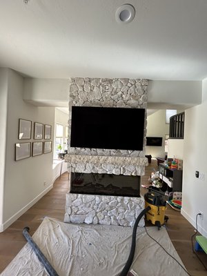 Tv on Stone wall perfectly centered, wires hidden - This project was done in a home with a stone accent wall above the fireplace.
