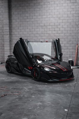 Gintani Mclaren 600LT - This was a very lengthy and very detailed project for us. Complete paint and carbon fiber claybarred and paint corrected to leave a mirror finish with no defects. Then before disassembling the car we installed the Precut clear XPEL paint protection film on the entire surface of the vehicles paint. All the factory grey accents were completely disassembled and wrapped in 3M satin black then reassembled. This includes the 3 pc front bumper scoops, door side skirts, inner door handle and panels, 2 quarter panel vents, engine cover, Rear spoiler, and the entire rear bumper/diffuser. Last touch was the red pinstripes on the diffuser, wheels, hood and front bumper and of course the companies logo on the hood stripe. Gintani Mclaren 600LT - This was a very lengthy and very detailed project for us. Complete paint and carbon fiber claybarred and paint corrected to leave a mirror finish with no defects. Then before disassembling the car we installed the Precut clear XPEL paint protection film on the entire surface of the vehicles paint. All the factory grey accents were completely disassembled and wrapped in 3M satin black then reassembled. This includes the 3 pc front bumper scoops, door side skirts, inner door handle and panels, 2 quarter panel vents, engine cover, Rear spoiler, and the entire rear bumper/diffuser. Last touch was the red pinstripes on the diffuser, wheels, hood and front bumper and of course the companies logo on the hood stripe.