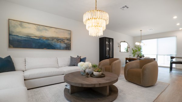 Warm & Inviting Living 2026 - This living room reflects the warm and luxurious setting the client envisioned. The chandelier above the coffee table enhances the space with a soft, inviting glow, adding to the warm atmosphere. Warm & Inviting Living 2026 - This living room reflects the warm and luxurious setting the client envisioned. The chandelier above the coffee table enhances the space with a soft, inviting glow, adding to the warm atmosphere.