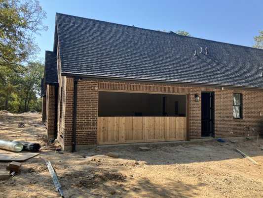 Custom wood overlay Garage Door - Client was building a custom home and wanted a nice custom door built to match their brick they will be staining the door soon to match all the wood trim around the house. Custom wood overlay Garage Door - Client was building a custom home and wanted a nice custom door built to match their brick they will be staining the door soon to match all the wood trim around the house.