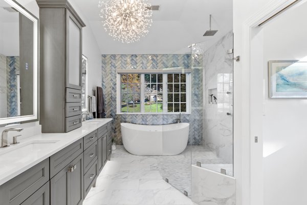 Bathroom Remodel 2025 - 1980’s Contemporary home in middle of wooded lot of Reston Neighborhood has been home to this young in heart couple.
Hey have recently sold their medical practice and wanted to enjoy some me time. The Master bath and bedroom renovation has been in their minds for years and now they have the time to attend to that long on hold dream
The plan was to convert the old run-down Master bath area to an Oasis of Spa for them to rest on.
Facing the south wooded backyard was the breathtaking scenery which was the perfect place for soaking tub,
Their space was tight and needed more floor space to add on. We took additional space from adjacent hallway and wasted sitting room by the way busting through few walls and add on to new bathroom for walk in shower stall and bigger double vanities. The private space for commode was one their top of the list requirement.
Spacy and Airey is what they have asked and what we delivered. Larger scale porcelain tile, big floor space, shower stall with lot of gadgets and rain shower, heated floors, heated towel rack, lighted medicine cabinetry, custom vanities and quartz counter top are just to name a few of this immaculate Oasis of Spa.
The carefully selected blue glass tile in the back wall has tied the large-scale porcelain marble tiles with blue veins.
The major difficulty of this project was relocating all plumbing for one side to other while adding space from adjacent sitting space. Routing all electrical and plumbing stack three level up, while being mindful of their newly remodeled main level kitchen just under this space.
The love their selection and color schemes chosen for this heavenly space. “ Can’t wait to dive into that Tub” is what she says Bathroom Remodel 2025 - 1980’s Contemporary home in middle of wooded lot of Reston Neighborhood has been home to this young in heart couple.
Hey have recently sold their medical practice and wanted to enjoy some me time. The Master bath and bedroom renovation has been in their minds for years and now they have the time to attend to that long on hold dream
The plan was to convert the old run-down Master bath area to an Oasis of Spa for them to rest on.
Facing the south wooded backyard was the breathtaking scenery which was the perfect place for soaking tub,
Their space was tight and needed more floor space to add on. We took additional space from adjacent hallway and wasted sitting room by the way busting through few walls and add on to new bathroom for walk in shower stall and bigger double vanities. The private space for commode was one their top of the list requirement.
Spacy and Airey is what they have asked and what we delivered. Larger scale porcelain tile, big floor space, shower stall with lot of gadgets and rain shower, heated floors, heated towel rack, lighted medicine cabinetry, custom vanities and quartz counter top are just to name a few of this immaculate Oasis of Spa.
The carefully selected blue glass tile in the back wall has tied the large-scale porcelain marble tiles with blue veins.
The major difficulty of this project was relocating all plumbing for one side to other while adding space from adjacent sitting space. Routing all electrical and plumbing stack three level up, while being mindful of their newly remodeled main level kitchen just under this space.
The love their selection and color schemes chosen for this heavenly space. “ Can’t wait to dive into that Tub” is what she says