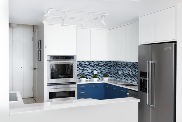Kitchen Remodel 2024 - Living in a high rise in the vibrant city of Chicago offers numerous perks- one of them being the breathtaking views of the skyline and shore of Lake Michigan. For one of our kitchen remodeling projects, we drew inspiration from this stunning vista to create a space that seamlessly blends together the components of functionality and aesthetics. However, it came with its own set of challenges as we had to work within a compact area and navigate a hard to work with concrete ledge compacting the kitchen even tighter.
Maximizing every inch of this space had been the main objective in this project.
To make the most of the available space, we opted for custom cabinets that allowed us to unleash our creativity and maximize storage capacity. We also integrated the concrete ledge into the cabinets to expand the working space as much as we could. Pull-out drawers, shelves, and rotating lazy susans were strategically incorporated in the millwork to then ensure accessibility and efficiency into organization. Such customizations enable usage of every nook and cranny while maintaining a sleek and clutter-free appearance within the rest of the kitchen.
Creating a space that perfectly balances functionality and aesthetics sometimes requires making compromises.
Since every inch had to be accounted for we had to be selective with the type of inserts we incorporated into the cabinetry. With conscious intent it had been decided to move against bulkier metal inserts in favor of those that offer optimal functionality within the limited space. While this choice may have limited some aesthetical options, it ensured that the kitchen was designed without obstruction to expansions of the space within while still being tailored to the homeowners needs.
To visually expand the kitchen we employed a few design techniques that helped guide the eye to produce the illusions of expansion. Large tiles were selected to help foster this illusion by reducing the number of grout lines and decrease the sense of "busyness" in the design. A white ceiling with encircling lights was utilized to disperse light evenly and create a sense of openness against the ceiling, while LED lighting was strategically placed to highlight key areas and add a touch of contemporary flare.
Standout feature out client fell in love with.
The star of the show and the standout feature of this kitchen is the captivating backsplash that have our client falling in love with their new kitchen every time they walk into it! With its seamless flow of custom glass tile it beautifully connects the interior to the stunning view of Lake Michigan right outside the high rise continuing the naturalistic changing lake colors in waves of vibrancy and vitality. This design choice not only emulates natures beauty in a cityscape apartment but also makes the kitchen feel more expansive, inviting the outdoors into the heart of the home!
New appliances that combine cutting-edge technology with sleek design added to the modernity of the space.
We had introduced an induction stove, offering both precise temperature control and energy efficiency, and embedded a compact oven into the millwork to save on counter space throughout the rest of the kitchen. A touch faucet adds convenience and a touch of elegance to the sink area, simplifying everyday tasks and was proposed to offer convenience to the clients as they worked to prep their meals.
We are overall delighted at the finished product, but even more so at our clients satisfaction of the space! Kitchen Remodel 2024 - Living in a high rise in the vibrant city of Chicago offers numerous perks- one of them being the breathtaking views of the skyline and shore of Lake Michigan. For one of our kitchen remodeling projects, we drew inspiration from this stunning vista to create a space that seamlessly blends together the components of functionality and aesthetics. However, it came with its own set of challenges as we had to work within a compact area and navigate a hard to work with concrete ledge compacting the kitchen even tighter.
Maximizing every inch of this space had been the main objective in this project.
To make the most of the available space, we opted for custom cabinets that allowed us to unleash our creativity and maximize storage capacity. We also integrated the concrete ledge into the cabinets to expand the working space as much as we could. Pull-out drawers, shelves, and rotating lazy susans were strategically incorporated in the millwork to then ensure accessibility and efficiency into organization. Such customizations enable usage of every nook and cranny while maintaining a sleek and clutter-free appearance within the rest of the kitchen.
Creating a space that perfectly balances functionality and aesthetics sometimes requires making compromises.
Since every inch had to be accounted for we had to be selective with the type of inserts we incorporated into the cabinetry. With conscious intent it had been decided to move against bulkier metal inserts in favor of those that offer optimal functionality within the limited space. While this choice may have limited some aesthetical options, it ensured that the kitchen was designed without obstruction to expansions of the space within while still being tailored to the homeowners needs.
To visually expand the kitchen we employed a few design techniques that helped guide the eye to produce the illusions of expansion. Large tiles were selected to help foster this illusion by reducing the number of grout lines and decrease the sense of "busyness" in the design. A white ceiling with encircling lights was utilized to disperse light evenly and create a sense of openness against the ceiling, while LED lighting was strategically placed to highlight key areas and add a touch of contemporary flare.
Standout feature out client fell in love with.
The star of the show and the standout feature of this kitchen is the captivating backsplash that have our client falling in love with their new kitchen every time they walk into it! With its seamless flow of custom glass tile it beautifully connects the interior to the stunning view of Lake Michigan right outside the high rise continuing the naturalistic changing lake colors in waves of vibrancy and vitality. This design choice not only emulates natures beauty in a cityscape apartment but also makes the kitchen feel more expansive, inviting the outdoors into the heart of the home!
New appliances that combine cutting-edge technology with sleek design added to the modernity of the space.
We had introduced an induction stove, offering both precise temperature control and energy efficiency, and embedded a compact oven into the millwork to save on counter space throughout the rest of the kitchen. A touch faucet adds convenience and a touch of elegance to the sink area, simplifying everyday tasks and was proposed to offer convenience to the clients as they worked to prep their meals.
We are overall delighted at the finished product, but even more so at our clients satisfaction of the space!