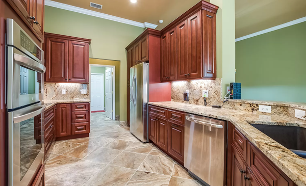 Whole House Remodel - This remodel included all new tile flooring and painting throughout.  Also new cabinets, countertops and granite backsplash.  First client to use the gold fixtures that are in use today.  Also included refinishing the pool deck, exterior paint and windows.