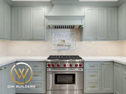 Kitchen Remodel | Burlingame - This kitchen remodel blends traditional and modern aesthetics with foam green shaker cabinets, brass hardware, and warm wood floors. Custom details like a pot filler, apron-front sink, and handmade tile elevate the design into a timeless yet welcoming space for everyday living.