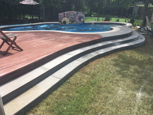 Pool Deck - This custom deck wraps around a curvy pool and has custom welded steps that mirror the curves of the pool. Pool Deck - This custom deck wraps around a curvy pool and has custom welded steps that mirror the curves of the pool.