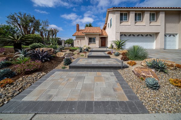 Carlsbad Landscape Update - This 35-year-old, neglected landscape has been transformed to feature beautiful, new approach along with upgraded outdoor living spaces. Unique, drought-tolerant landscaping and low-maintenance artificial turf enhance the surrounding spaces, providing year-round color, texture, form and functionality.