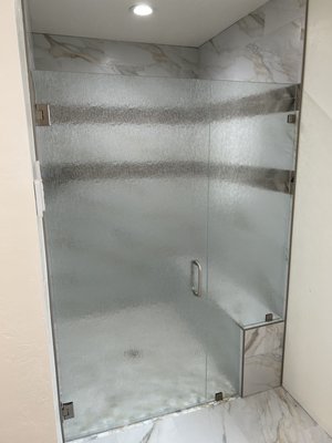 Rain Glass Install. Price, Utah 2025 - This install features a rain glass fixed panel and matching swing door, adding privacy and texture to the space. The patterned glass complements the bathroom’s style while still letting in light, creating a stylish upgrade.
