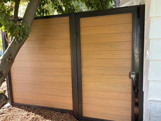 COMPUST GATE (TREX) METAL FRAME WITH KEY OR PIN PAD LOCK - These doors are one of the newest trends on the market right now. They are fully custom-made to fit each client’s style and preferences.
The material used is composite wood, a wood-like plastic also known as Trex, which offers a modern and innovative option for homes or new construction projects with a more contemporary design.
These doors are built to be extremely durable and long-lasting—far more than a standard wooden door—since the entire frame is made of metal.
We also offer different locking options, including traditional key locks or modern pin pad systems for added convenience and security. COMPUST GATE (TREX) METAL FRAME WITH KEY OR PIN PAD LOCK - These doors are one of the newest trends on the market right now. They are fully custom-made to fit each client’s style and preferences.
The material used is composite wood, a wood-like plastic also known as Trex, which offers a modern and innovative option for homes or new construction projects with a more contemporary design.
These doors are built to be extremely durable and long-lasting—far more than a standard wooden door—since the entire frame is made of metal.
We also offer different locking options, including traditional key locks or modern pin pad systems for added convenience and security.