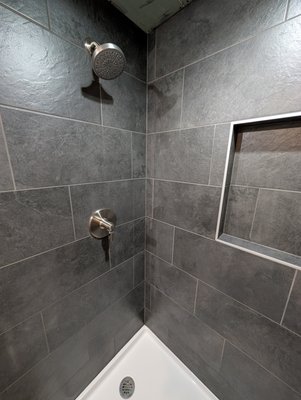 Partial Bathroom Build. Heated floors! - This remodel was done on a basement slab. The owner was concerned with the floors being cold in the winter time, so we installed heated floors below the tile. It was a process as the floors were out of level by 3 inches. We leveled the floors, installed an uncoupling membrane, and finally installed the heated floors before installing the tiles. we install and custom niche in the shower. All tiles and design decisions were performed by the client. They had a vision, and we made it reality. Partial Bathroom Build. Heated floors! - This remodel was done on a basement slab. The owner was concerned with the floors being cold in the winter time, so we installed heated floors below the tile. It was a process as the floors were out of level by 3 inches. We leveled the floors, installed an uncoupling membrane, and finally installed the heated floors before installing the tiles. we install and custom niche in the shower. All tiles and design decisions were performed by the client. They had a vision, and we made it reality.