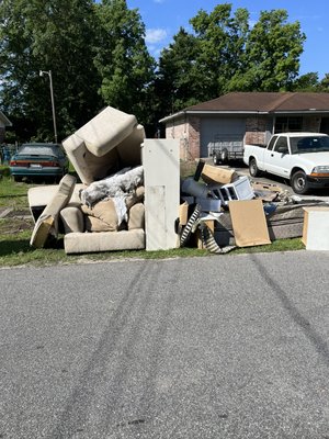 Curbside home clean out - Home cleaned out and unwanted items and trash places curbside. Curbside home clean out - Home cleaned out and unwanted items and trash places curbside.