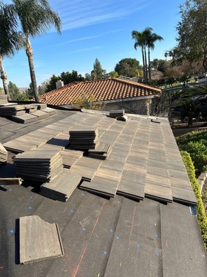New Tile roof - Tore off existing concrete flat tile on the house. Installed new 2”x4” white edge
metal on all eaves. Installed 2 layers of 30# ASTM felt nailing down in place using 7⁄8” plastic cap nails,
chalked guidelines and prepped roof for new tile load. Installed new flat concrete tile on the entire house using 8D galvanized nails. Installed 8 tile vents to allow heat to escape attic space. Installed new rake trim using 3” deck screws. Installed new ridge trim using 16D nails. Installed all new valley metal and flashing metal on all vent pipes (2 per pipe). Installed all new tile pan metal. Caulked and painted all vent flashings to match roof color. New Tile roof - Tore off existing concrete flat tile on the house. Installed new 2”x4” white edge
metal on all eaves. Installed 2 layers of 30# ASTM felt nailing down in place using 7⁄8” plastic cap nails,
chalked guidelines and prepped roof for new tile load. Installed new flat concrete tile on the entire house using 8D galvanized nails. Installed 8 tile vents to allow heat to escape attic space. Installed new rake trim using 3” deck screws. Installed new ridge trim using 16D nails. Installed all new valley metal and flashing metal on all vent pipes (2 per pipe). Installed all new tile pan metal. Caulked and painted all vent flashings to match roof color.