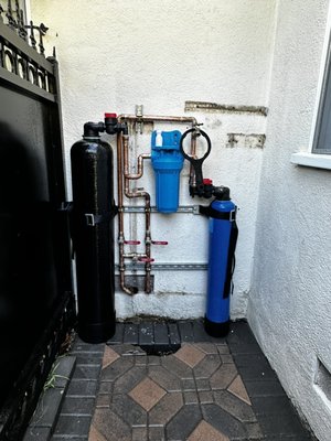 Whole house water filtration - Customer requested older inoperable whole house filtration unit be removed and replaced with their supplied filtration unit.