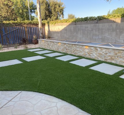 Back Yard Remodel - This project was a remodel in Visalia Ca, Added raised planter/seating wall with hardscape lights. Turf with  concrete steppers. Fresh gravel and new plants all watered with a wifi timer from the comfort of your phone.