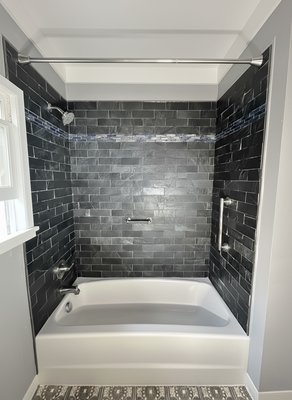 Bathroom Shower Remodel - Upgraded a shower from plastic wall panels to full tile installation. Walls were repainted and the window trim was finished in white for a fresh, modern look. Bathroom Shower Remodel - Upgraded a shower from plastic wall panels to full tile installation. Walls were repainted and the window trim was finished in white for a fresh, modern look.